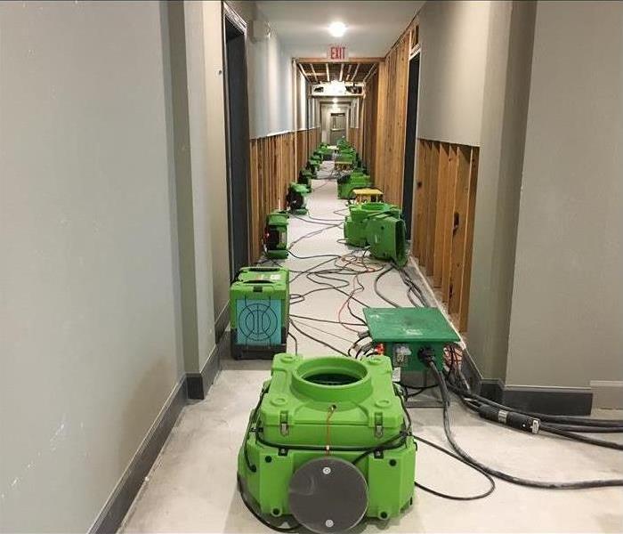 Air movers placed in the hall of a building