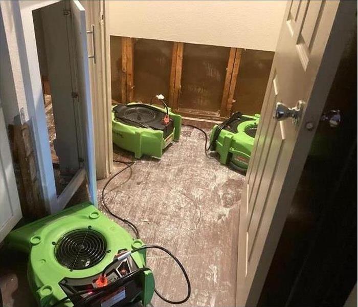 three air movers placed beside drywall, flood cuts performed to drywall