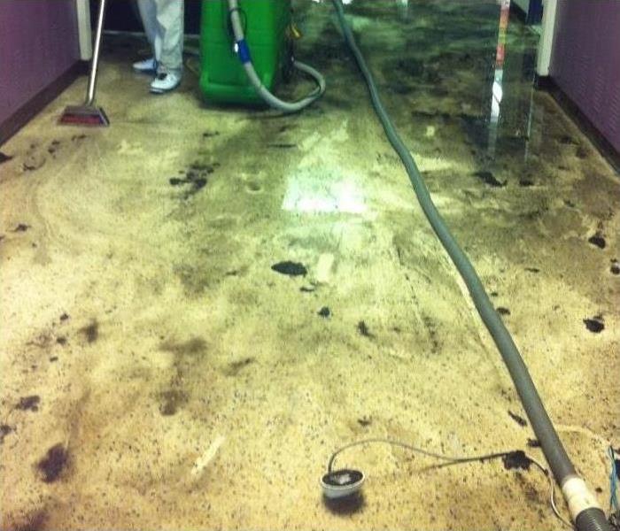 wet floor with soot, technician extracting water from the floor